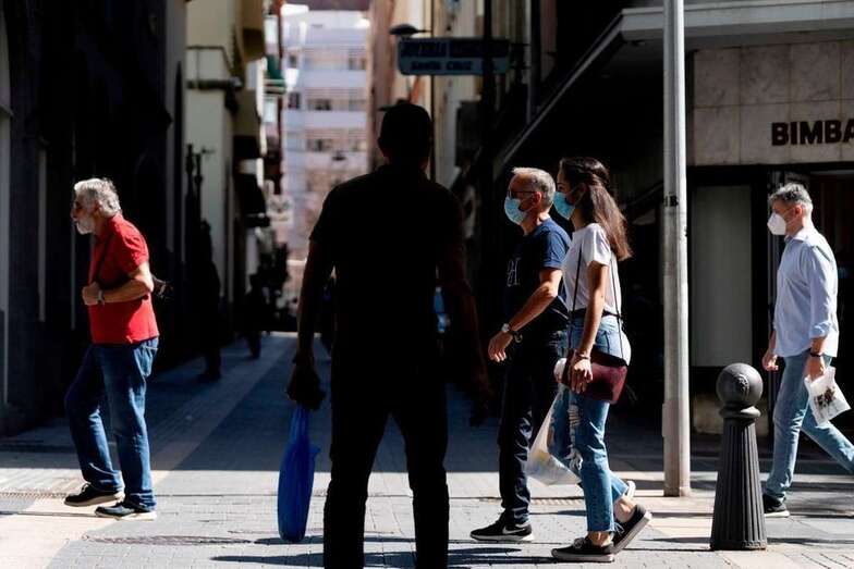 Gente con mascarillas/TDC.